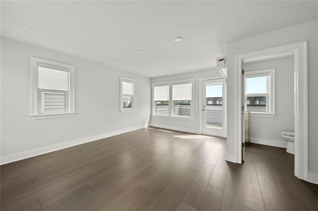 1012 Burnside Ln. Northwest Atlanta, GA 30318 - Photo 28 of 36 a view of an empty room with wooden floor and a window