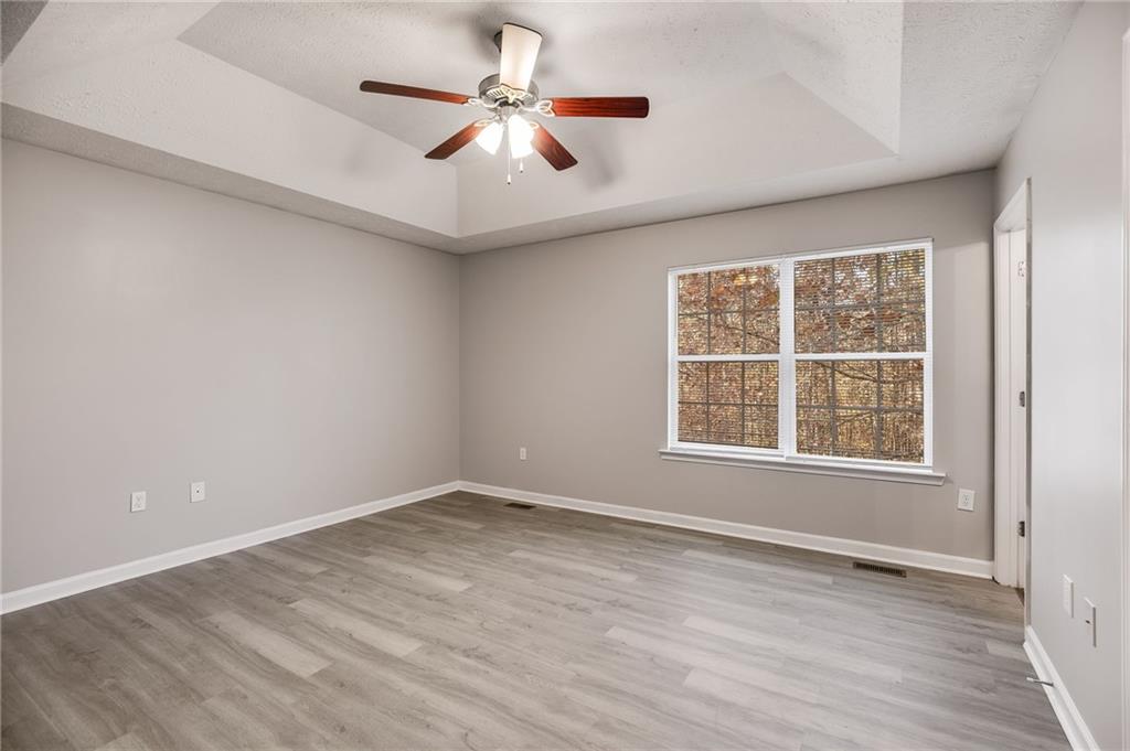 18 Twin Oaks Lane Dallas, GA 30157 - Photo 13 of 24 an empty room with wooden floor fan and windows