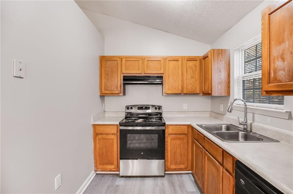 18 Twin Oaks Lane Dallas, GA 30157 - Photo 7 of 24 a kitchen with a sink stove top oven and cabinets