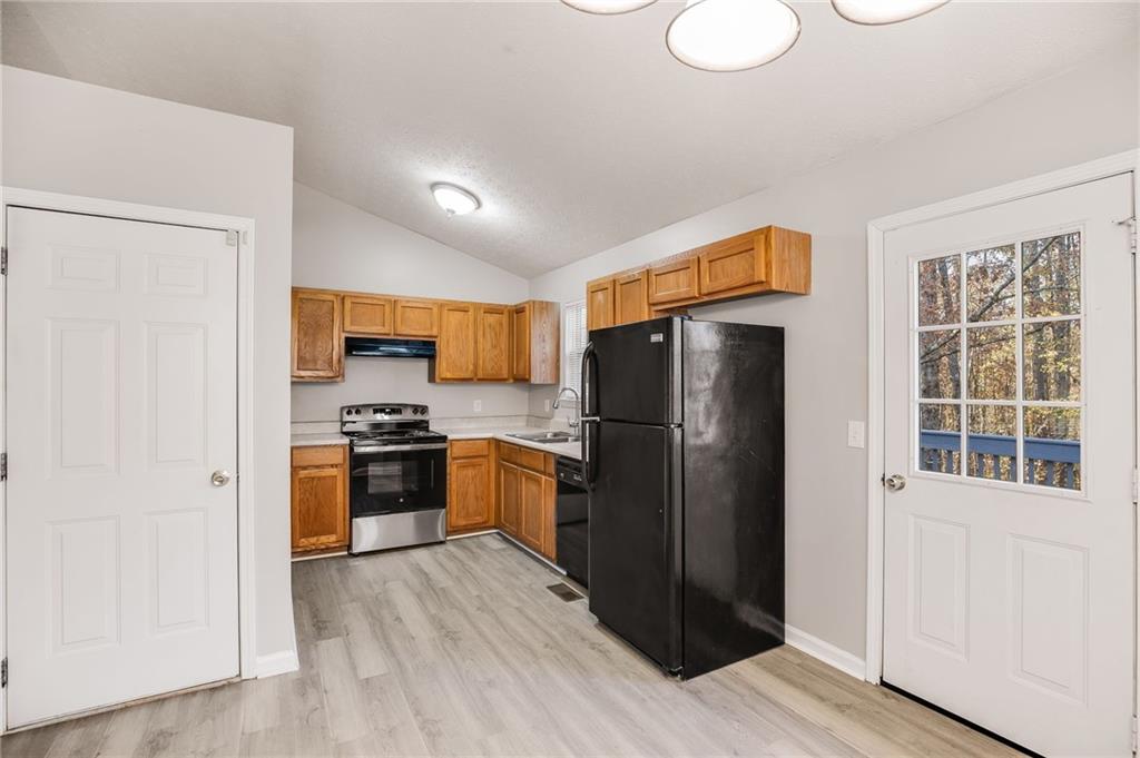 18 Twin Oaks Lane Dallas, GA 30157 - Photo 8 of 24 a kitchen with stainless steel appliances granite countertop a refrigerator stove and sink