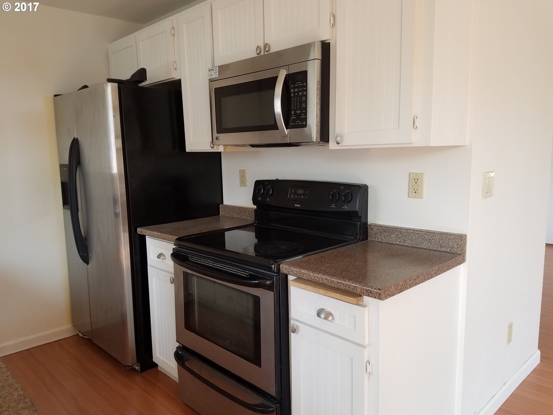 819 Southwest 9th Street Pendleton, OR 97801 - Photo 4 of 20 a kitchen with granite countertop cabinets stainless steel appliances and wooden floor
