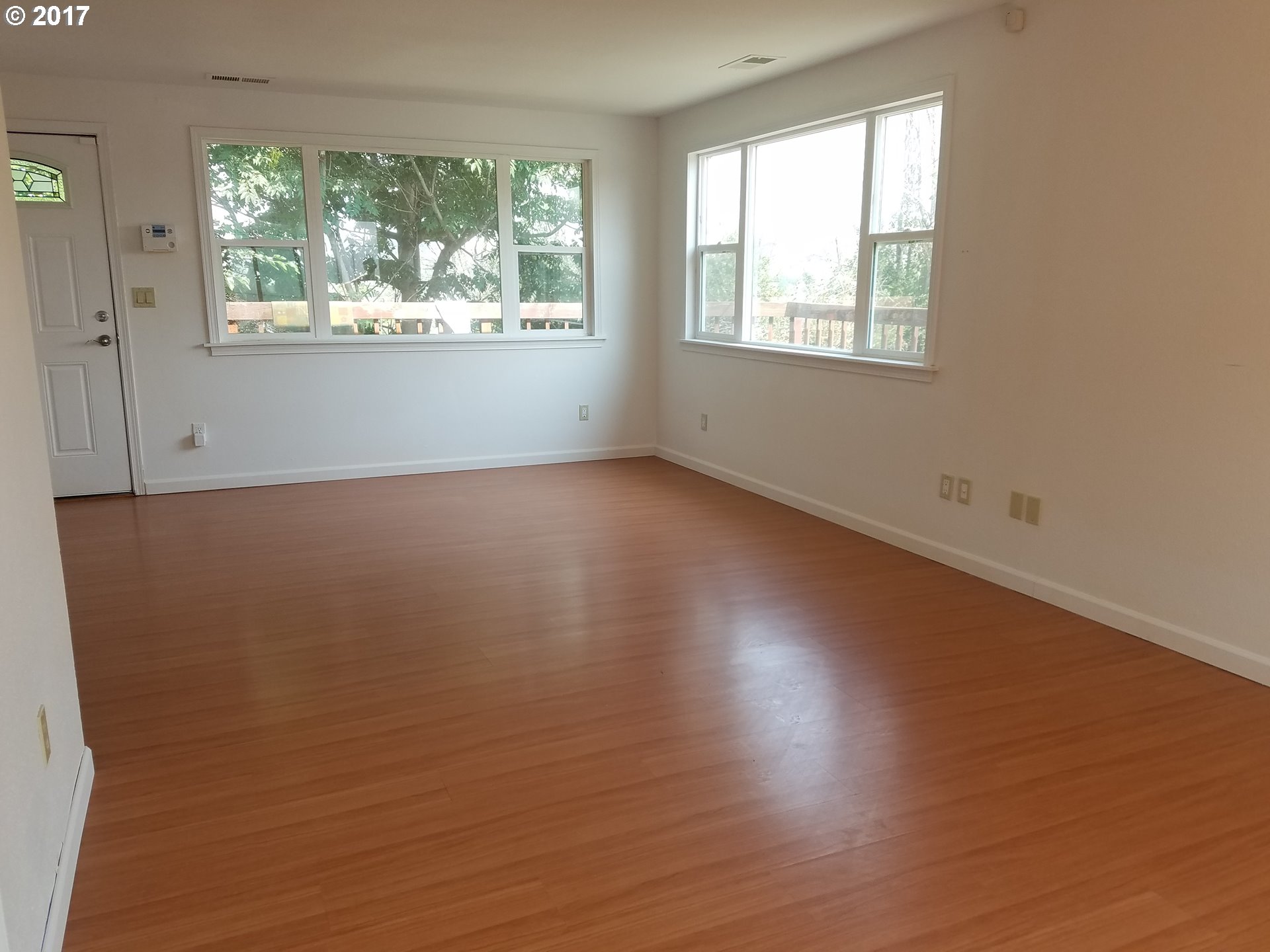 819 Southwest 9th Street Pendleton, OR 97801 - Photo 5 of 20 an empty room with wooden floor and windows