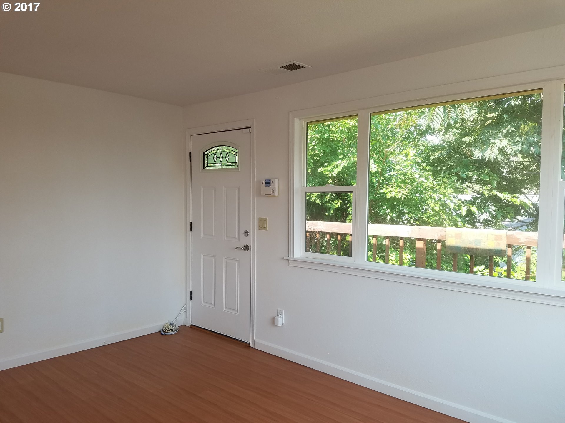 819 Southwest 9th Street Pendleton, OR 97801 - Photo 6 of 20 a view of an empty room with wooden floor and a window