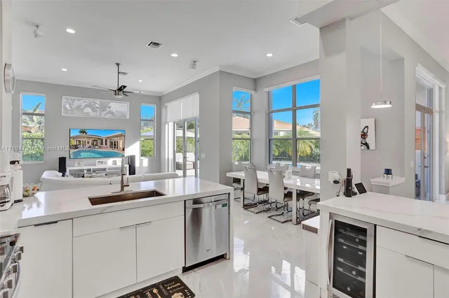 a large kitchen with lots of counter space a sink and windows
