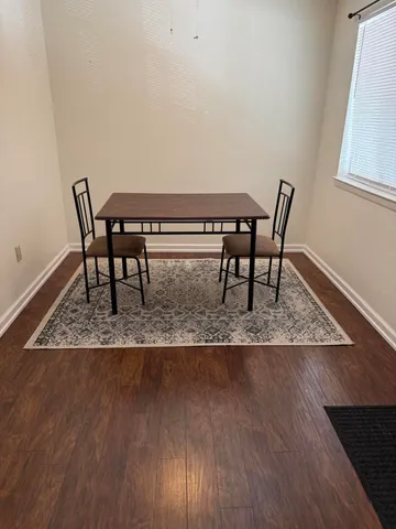a view of a dining room with furniture and wooden floor