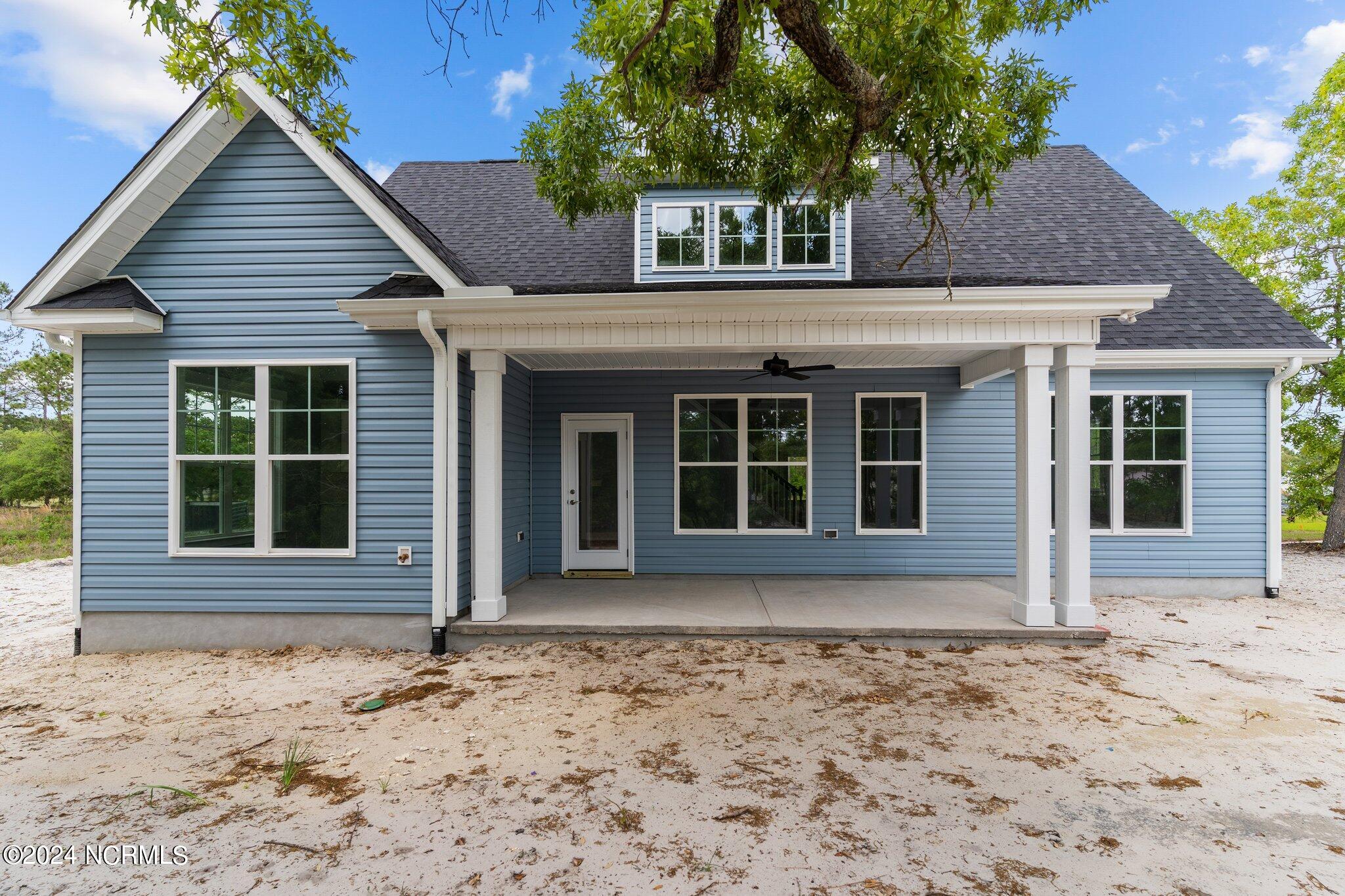 520 Barber Road Southport, NC 28461 - Photo 3 of 34 Lots of privacy and large lot with hardwood trees, views of golf course and culdesac lot, final seed and straw in back to be placed