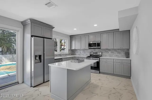 a kitchen with a refrigerator sink and microwave