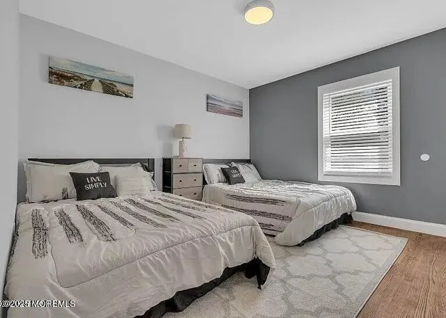 a bedroom with two beds and a window