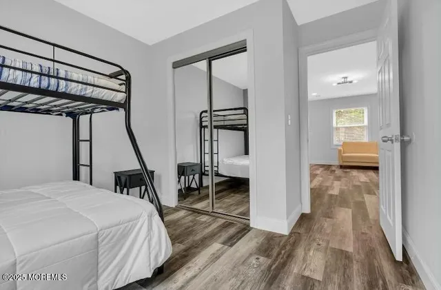 a bedroom with a bed table and a window