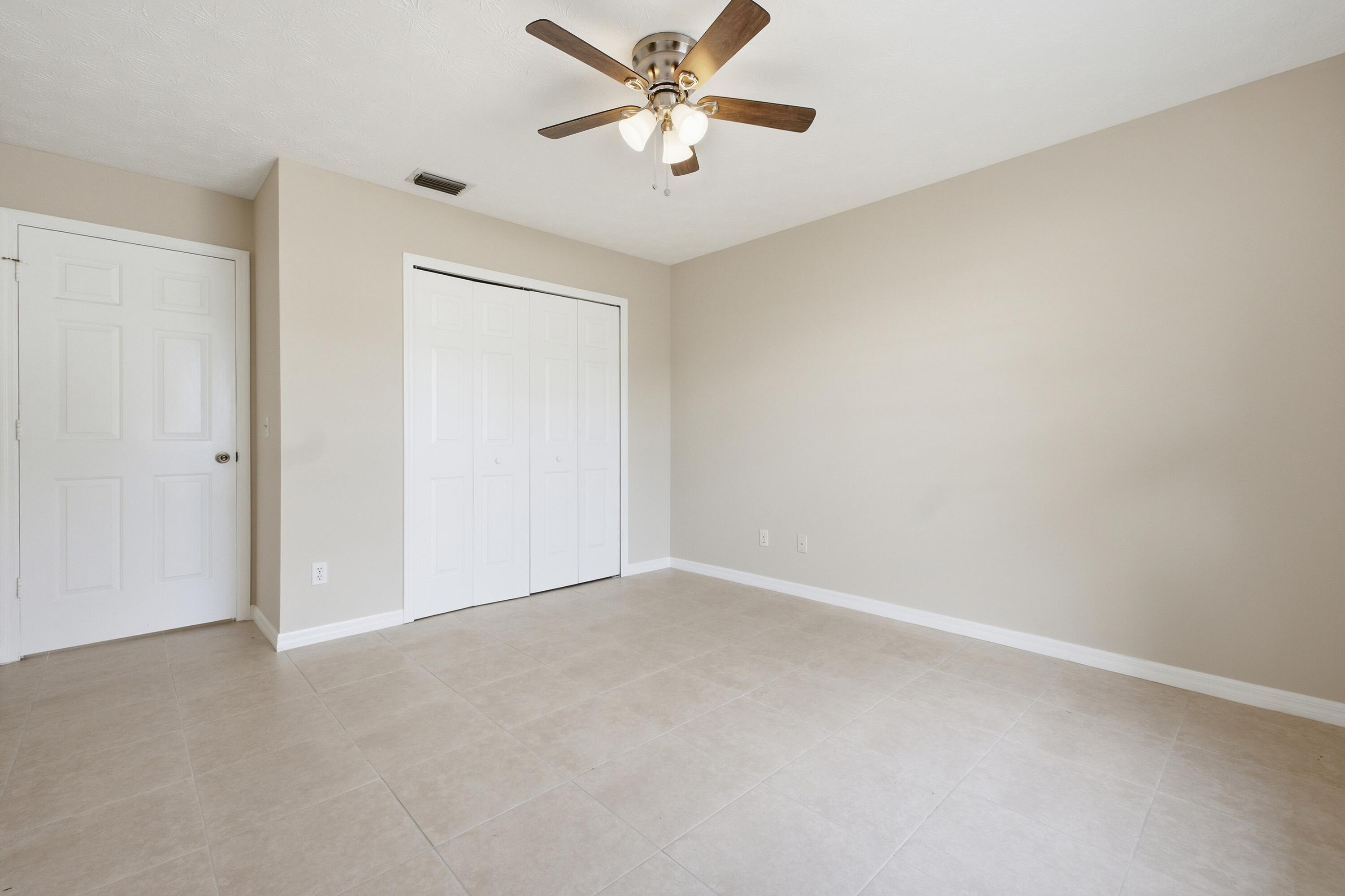5809 Killarney Avenue Fort Pierce, FL 34951 - Photo 12 of 29 an empty room with closet and a ceiling fan