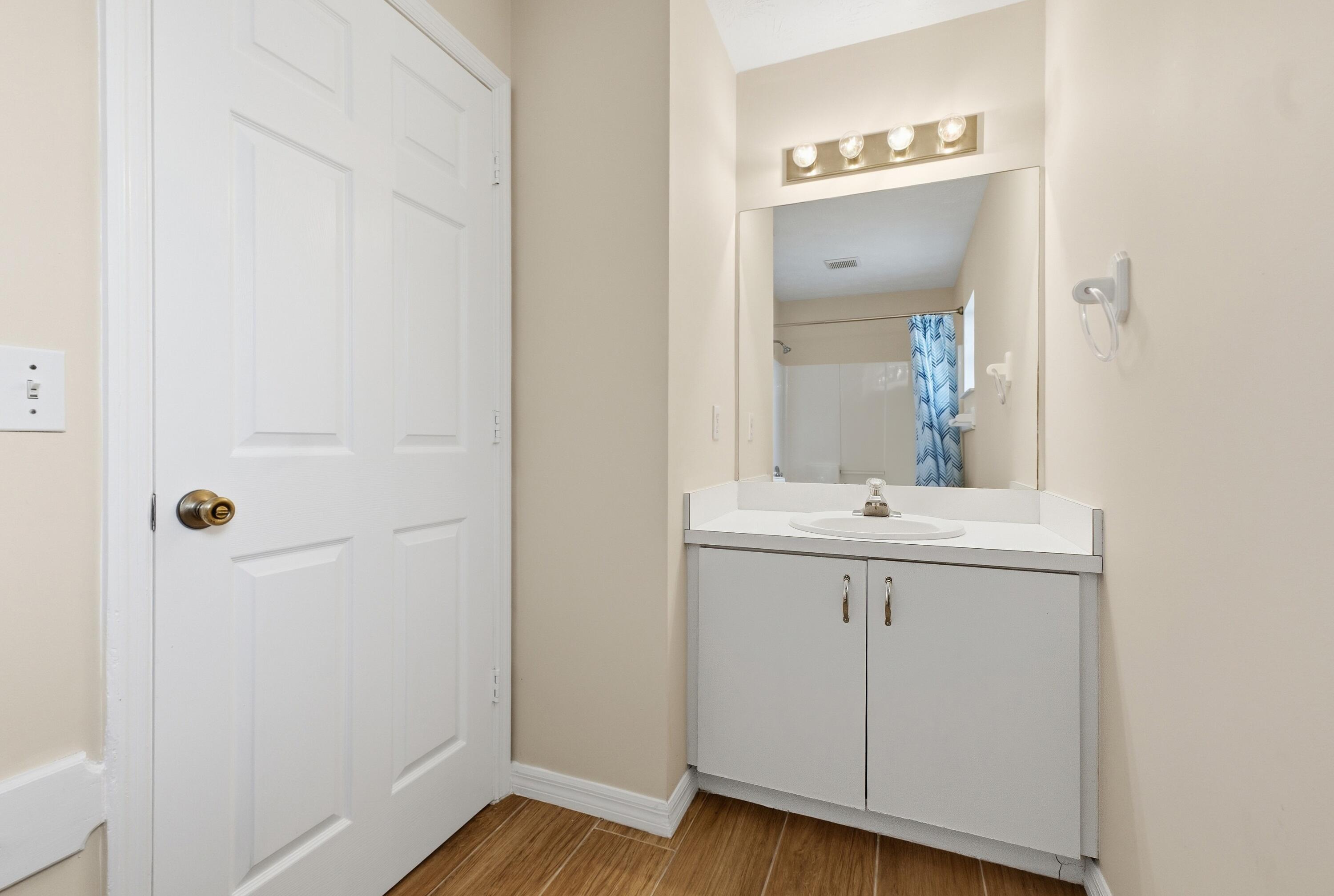 5809 Killarney Avenue Fort Pierce, FL 34951 - Photo 13 of 29 a bathroom with a sink and mirror