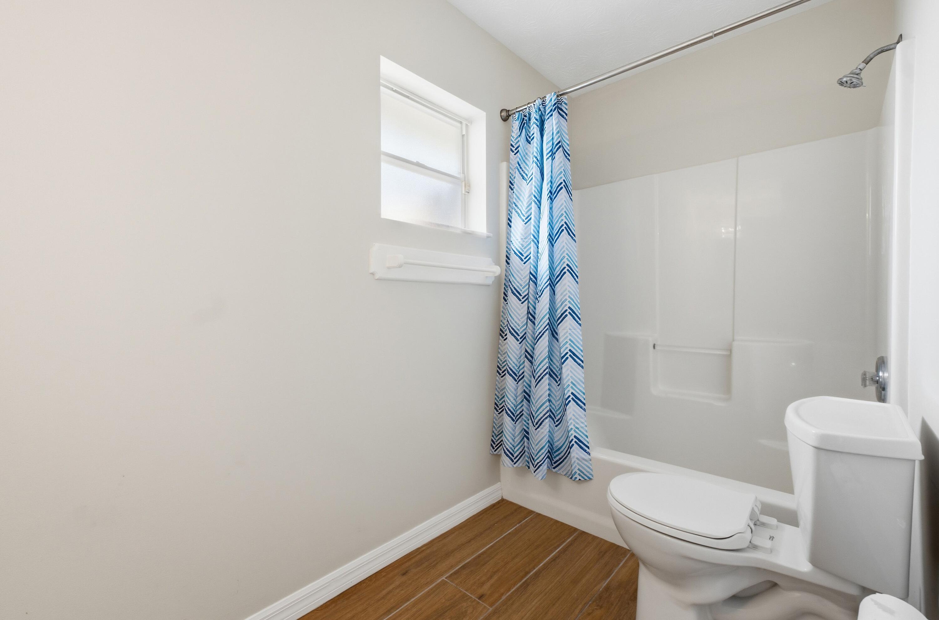 5809 Killarney Avenue Fort Pierce, FL 34951 - Photo 14 of 29 a bathroom with a toilet a sink and shower