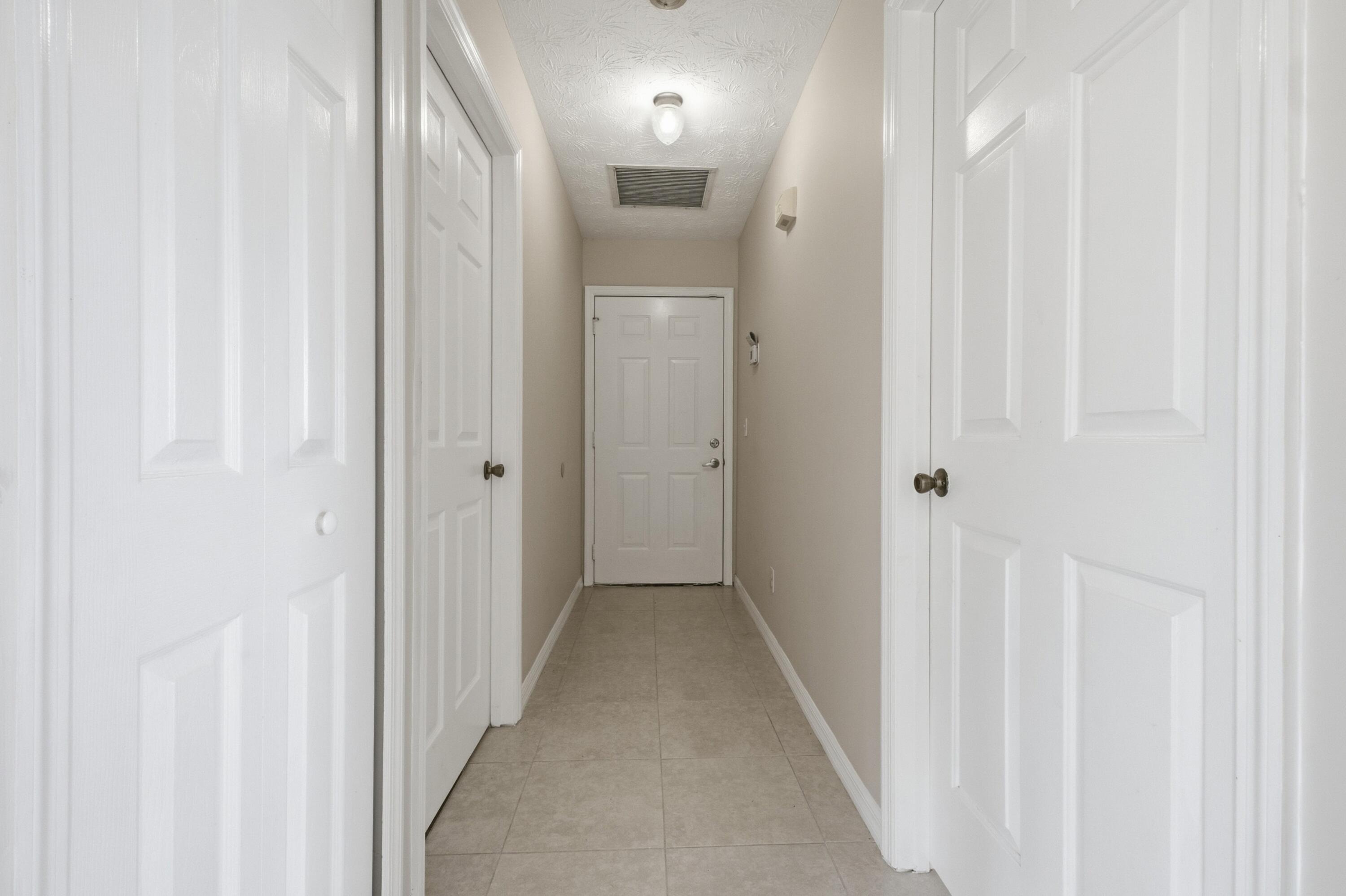 5809 Killarney Avenue Fort Pierce, FL 34951 - Photo 16 of 29 a view of a hallway with wooden floor