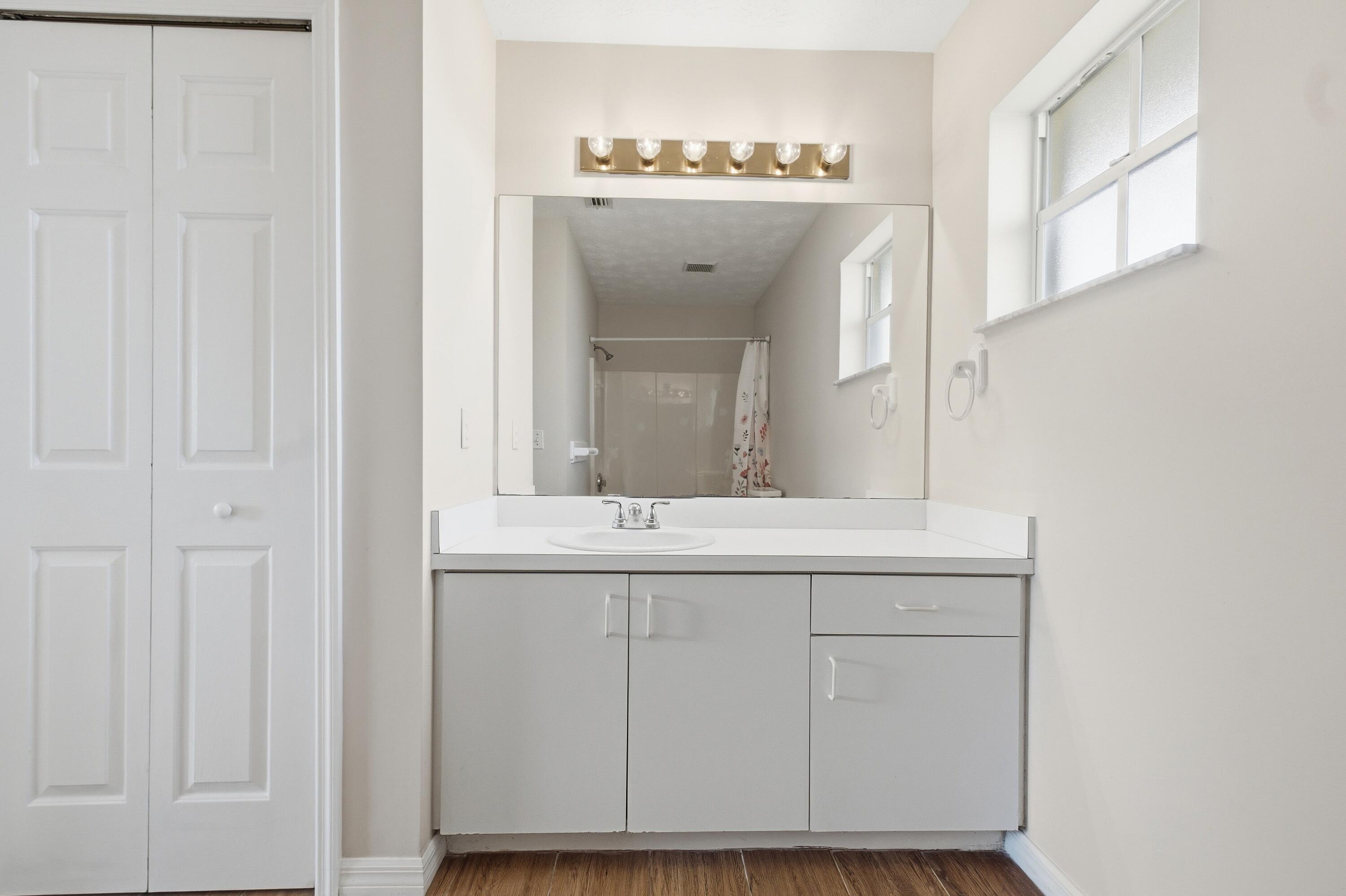5809 Killarney Avenue Fort Pierce, FL 34951 - Photo 18 of 29 a bathroom with a sink and a mirror