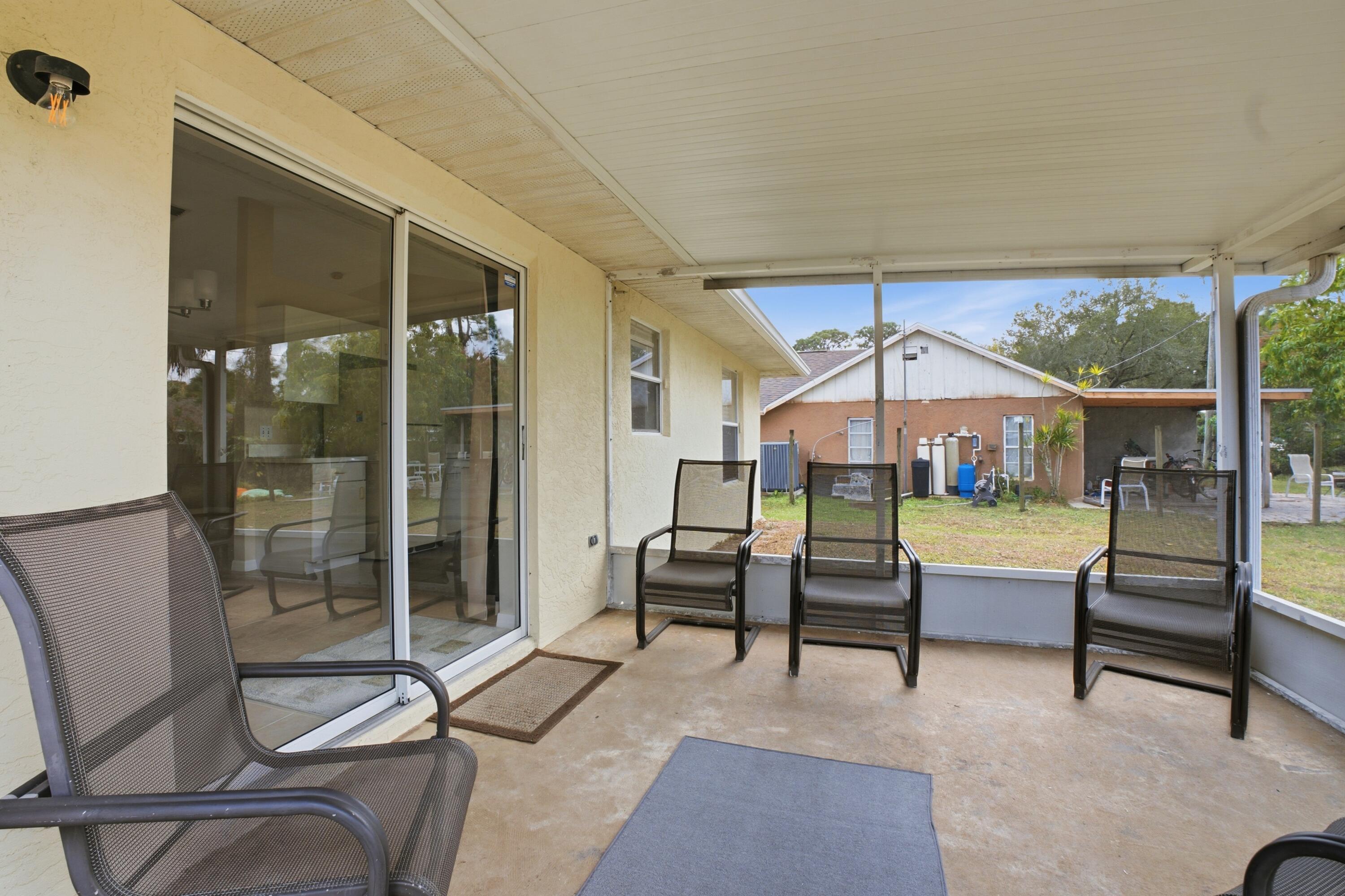 5809 Killarney Avenue Fort Pierce, FL 34951 - Photo 21 of 29 a bedroom with a bed and a view of the balcony