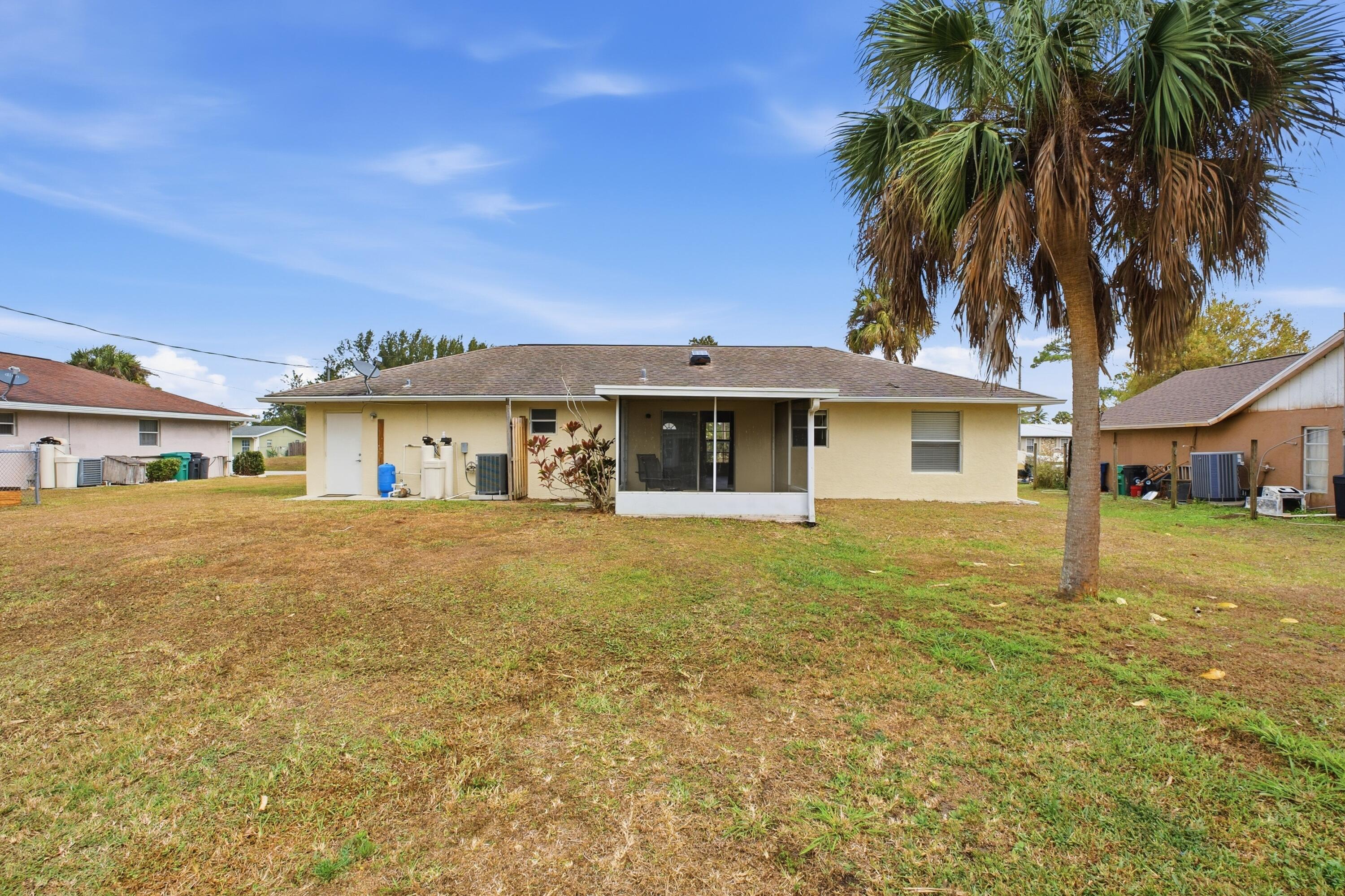 5809 Killarney Avenue Fort Pierce, FL 34951 - Photo 25 of 29 a front view of a house with a garden and tree