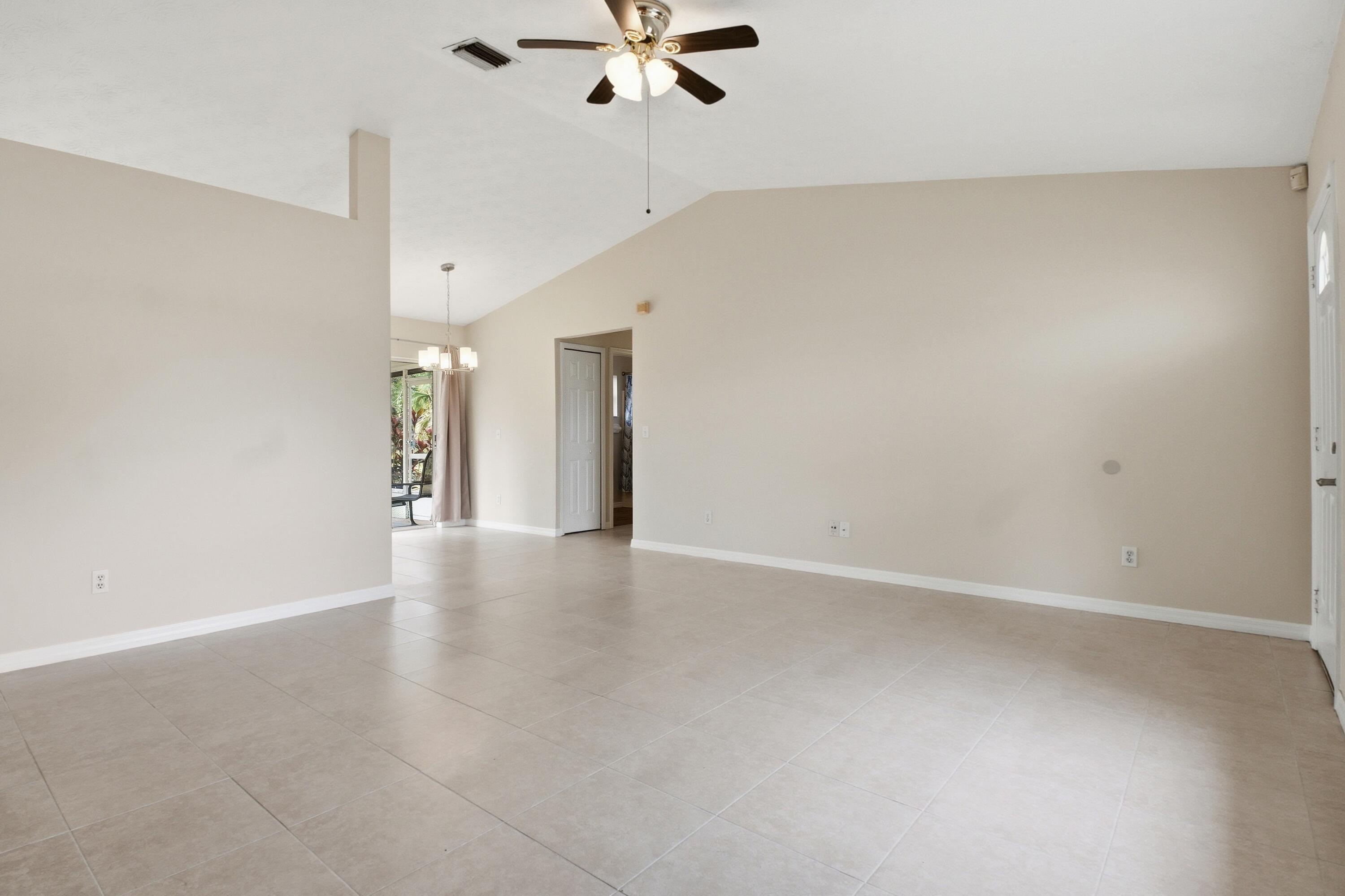 5809 Killarney Avenue Fort Pierce, FL 34951 - Photo 4 of 29 a view of an empty room with a ceiling fan