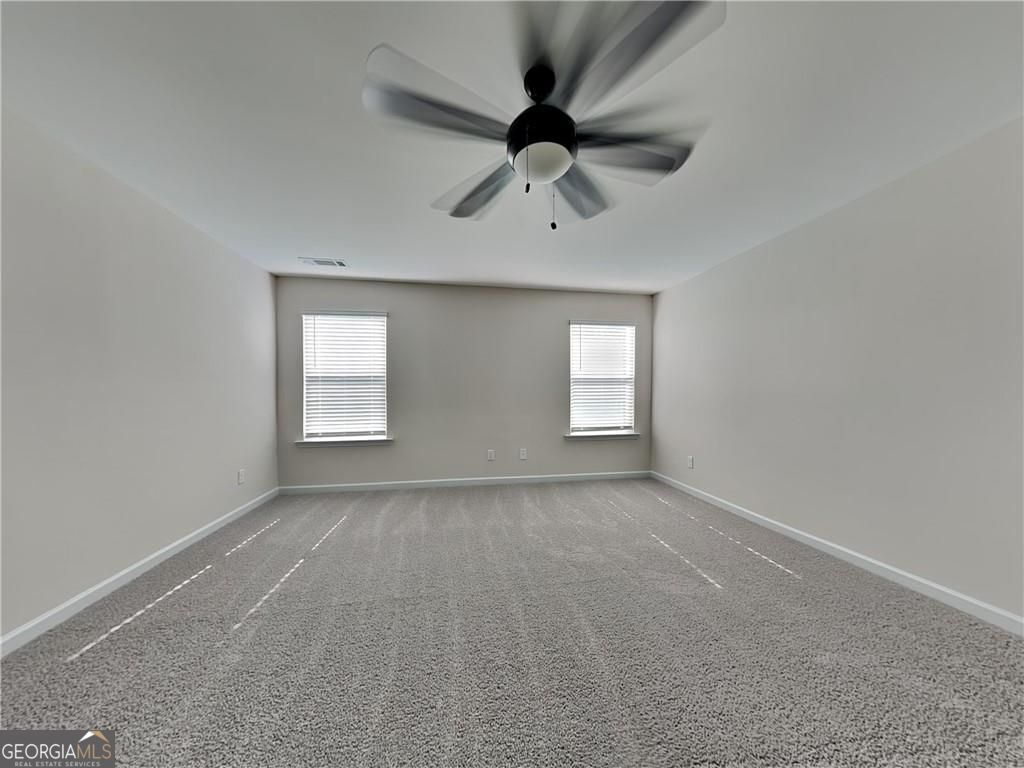 3323 Arabian Farm Lane Dacula, GA 30019 - Photo 14 of 24 an empty room with a window and a fan