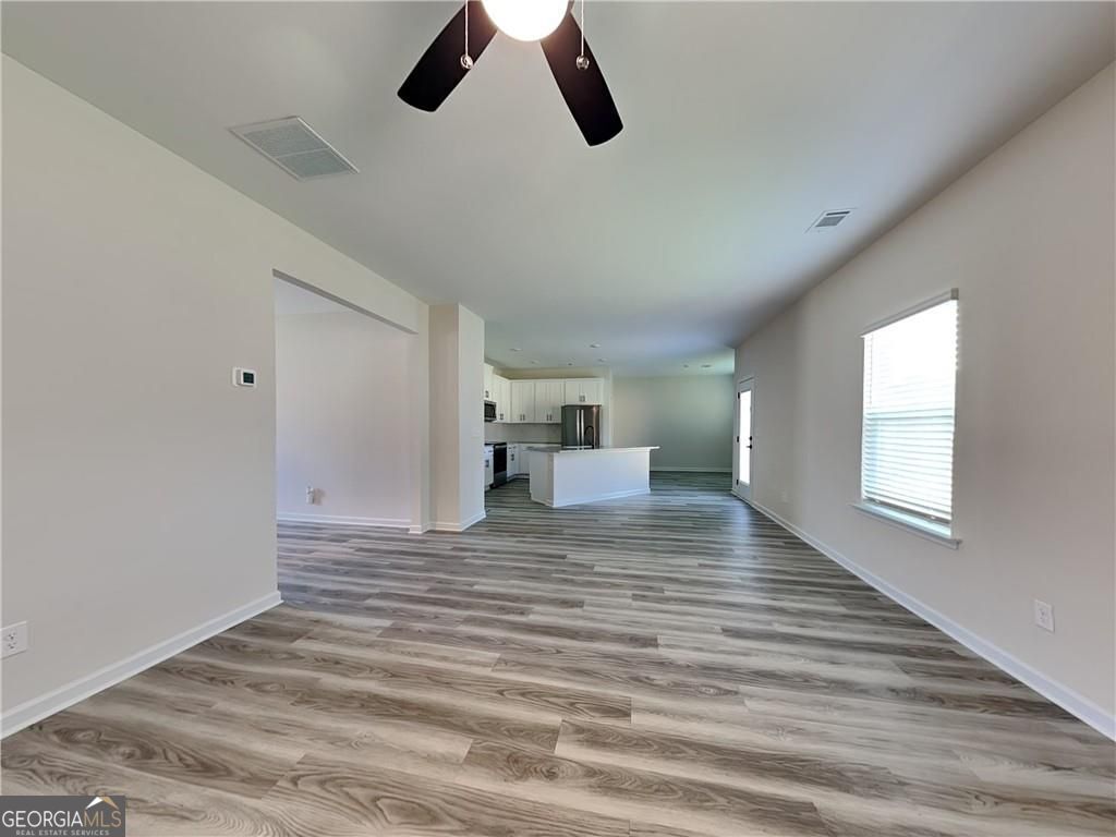 3323 Arabian Farm Lane Dacula, GA 30019 - Photo 4 of 24 a view of empty room with wooden floor