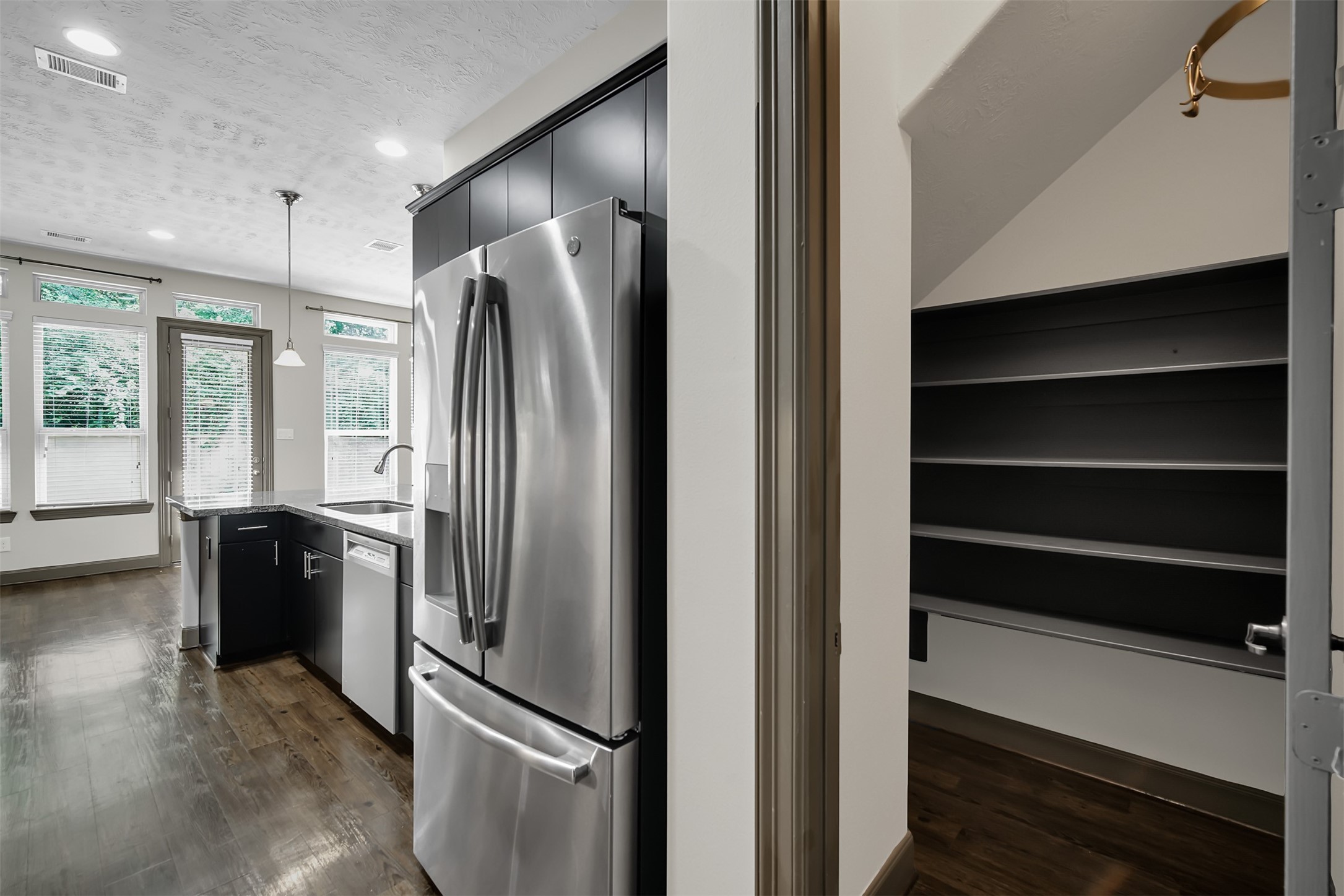 111 Aventura Place Spring, TX 77389 - Photo 19 of 42 a metallic refrigerator freezer sitting in a kitchen