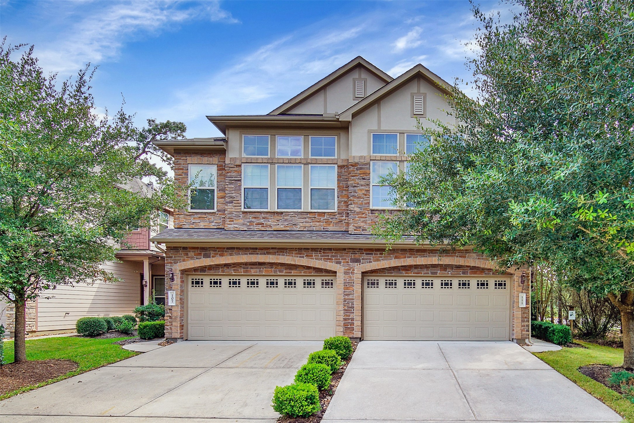 111 Aventura Place Spring, TX 77389 - Photo 2 of 42 a front view of a house with a garden and trees