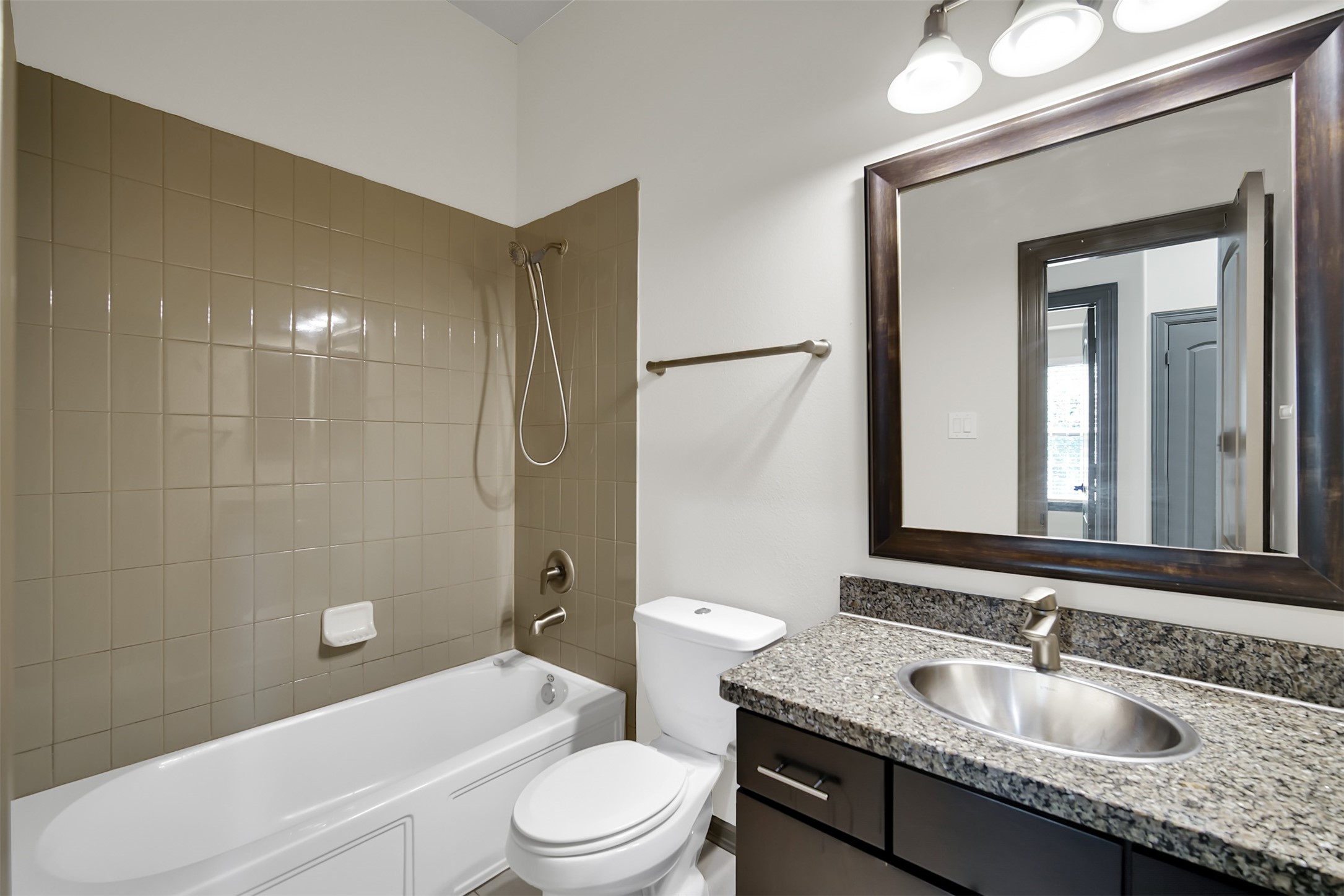 111 Aventura Place Spring, TX 77389 - Photo 28 of 42 a bathroom with a granite countertop sink a toilet and shower