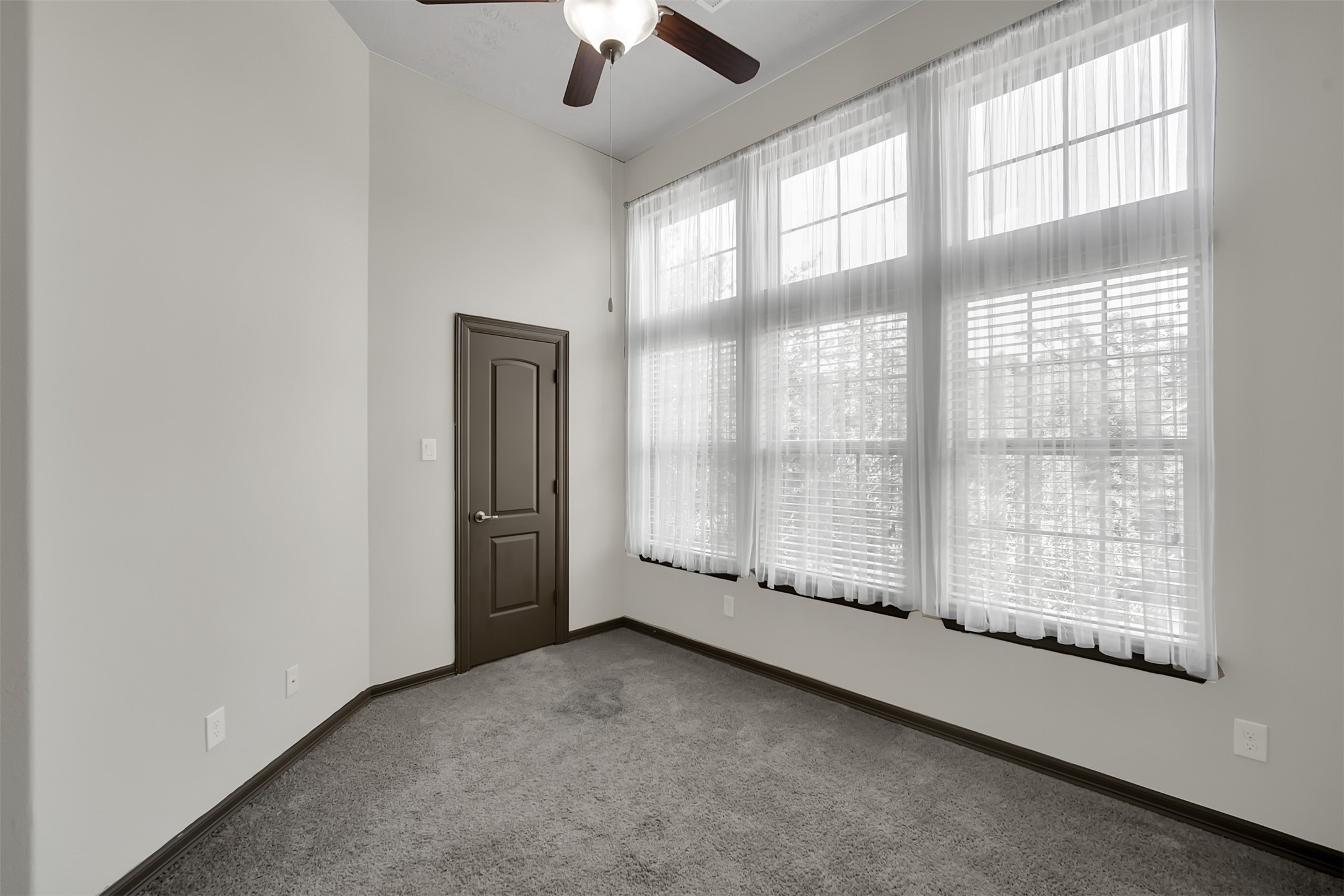 111 Aventura Place Spring, TX 77389 - Photo 29 of 42 an empty room with chandelier fan and windows