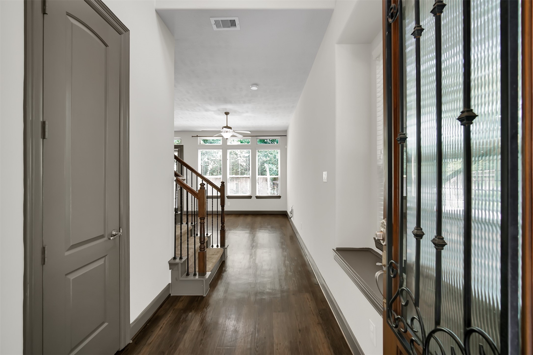 111 Aventura Place Spring, TX 77389 - Photo 4 of 42 a view of a hallway with wooden floor and staircase