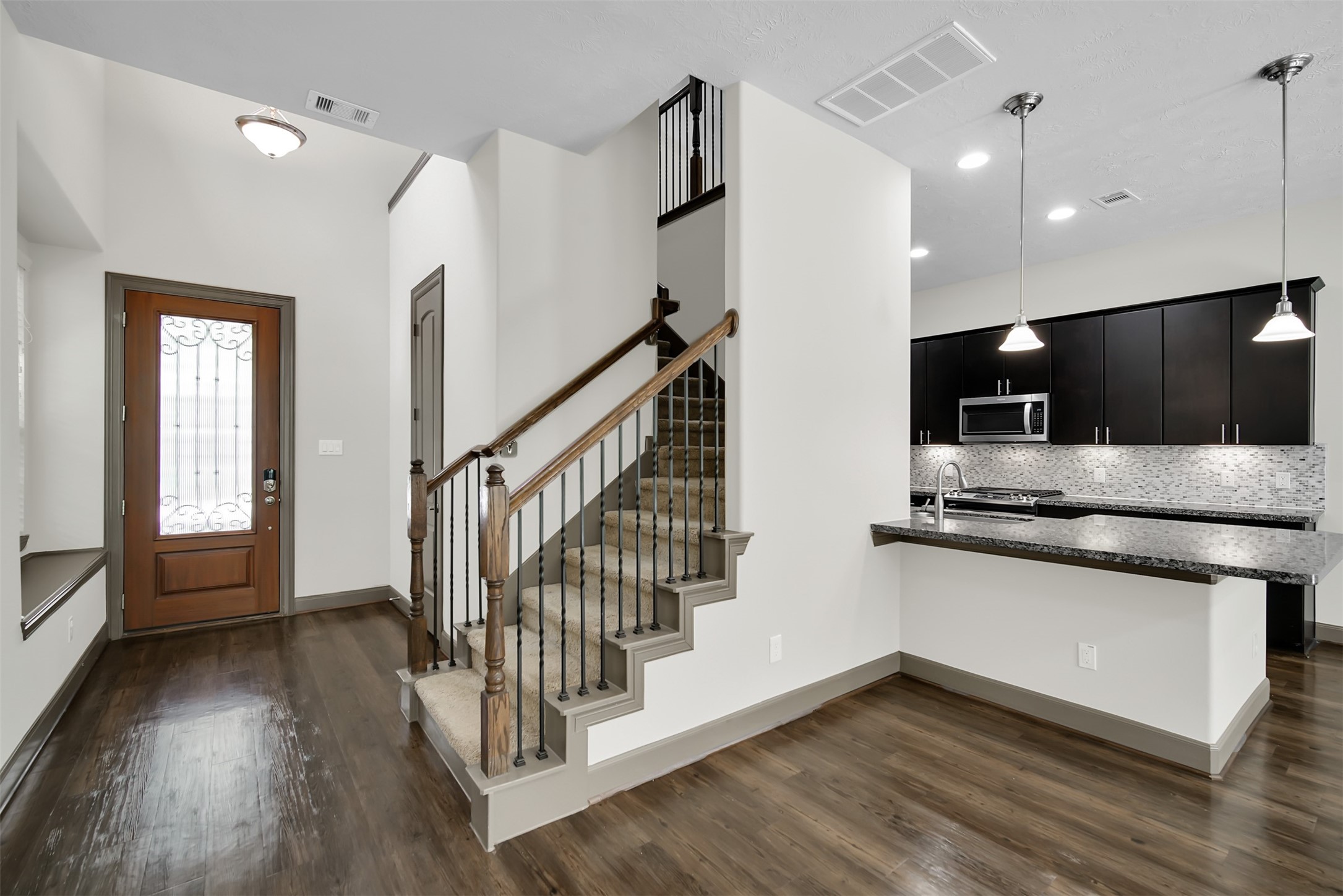 111 Aventura Place Spring, TX 77389 - Photo 6 of 42 a view of kitchen with stainless steel appliances granite countertop a stove and a wooden floors