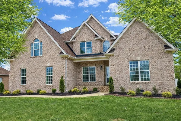 a kitchen with a sink a stove and chairs with wooden floor