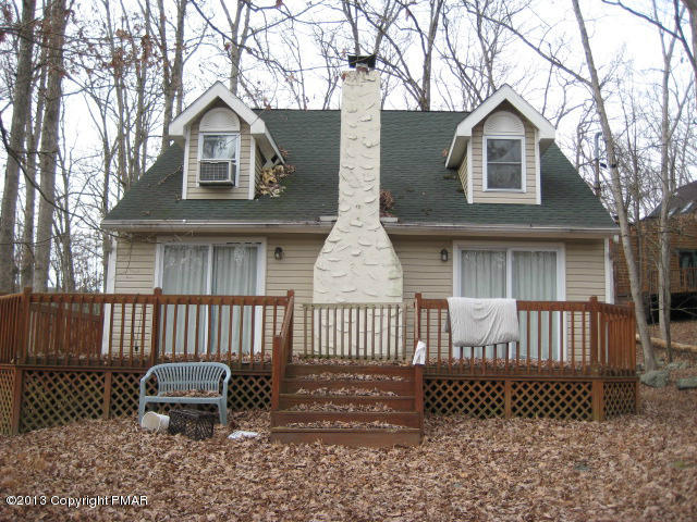 6216 Decker Road Bushkill, PA 18324 - Photo 1 of 8 a view of a brick house with a small yard and wooden fence