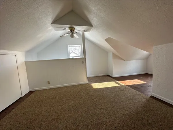 a view of empty room with a fan
