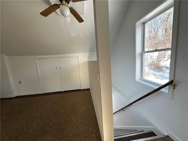 a view of a room with rack on the wall and a window