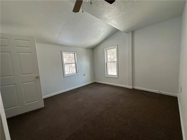 an empty room with windows and closet