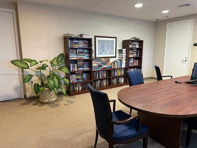 a living room with furniture and a bookshelf