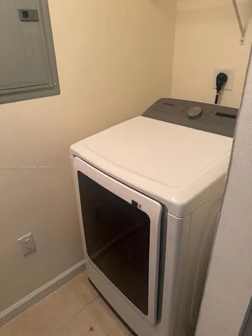 a living room with furniture and a dining table
