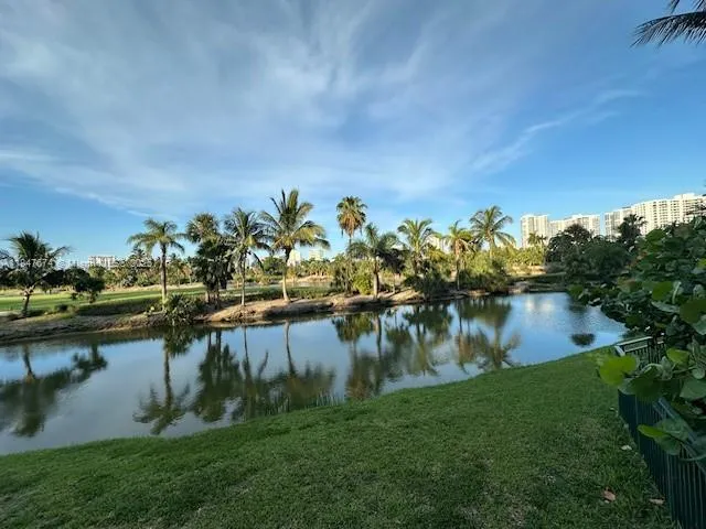 a view of a lake with houses in the back