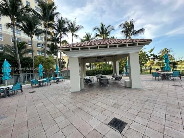 a view of a patio with table and chairs and potted plants