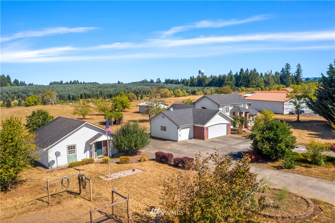 165 Conradi Road Winlock, WA 98596 - Photo 3 of 40 an aerial view of a house with a garden and lake view