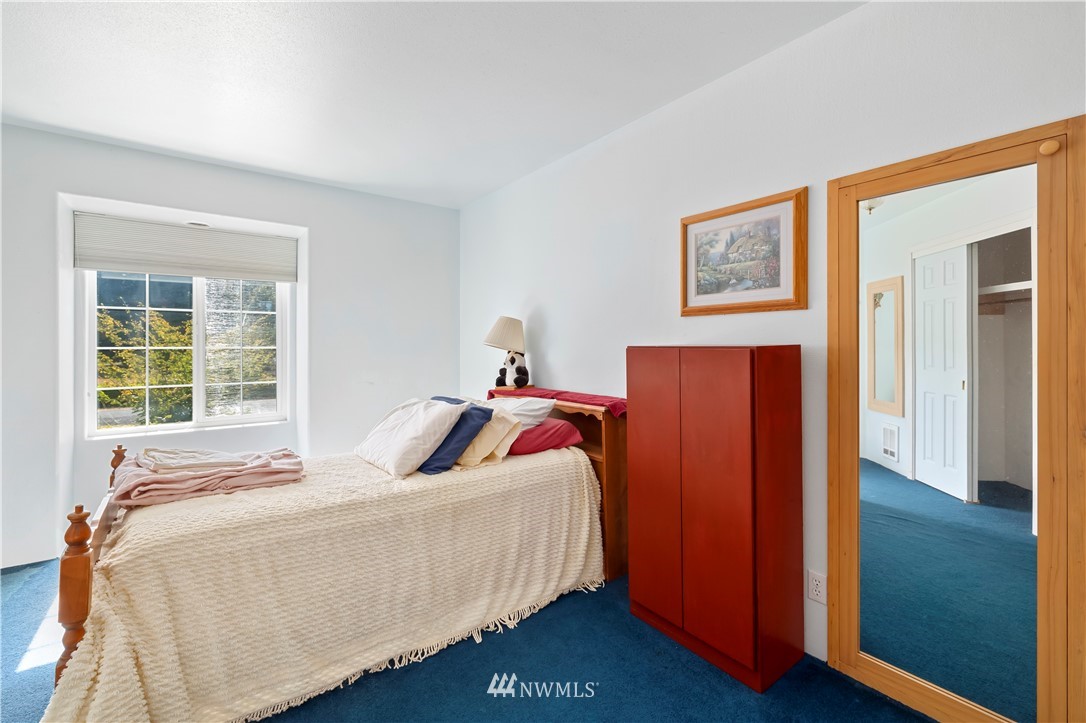 165 Conradi Road Winlock, WA 98596 - Photo 24 of 40 a bedroom with bed and wooden floor