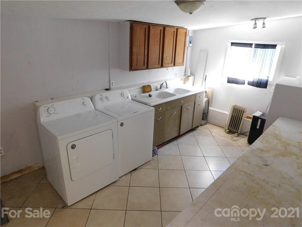110 Blue Ridge Road Campobello, SC 29322 - Photo 22 of 26 a view of a storage utility room with a sink a washer and dryer