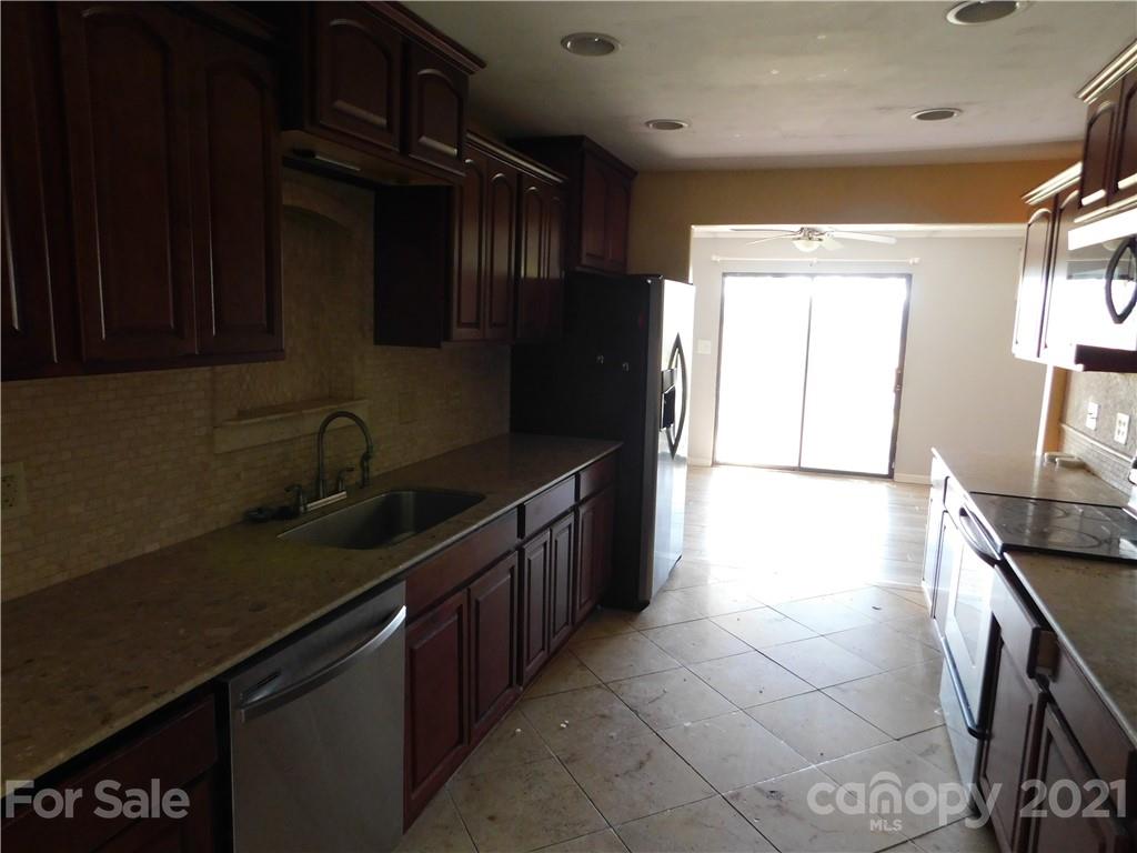110 Blue Ridge Road Campobello, SC 29322 - Photo 8 of 26 a kitchen with a sink stove and cabinets