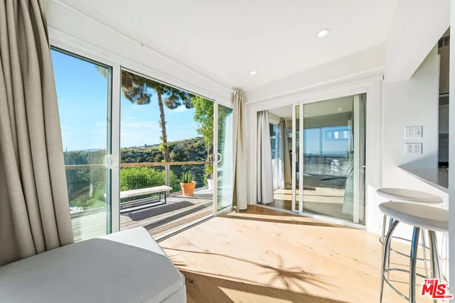 a room with large windows and a balcony