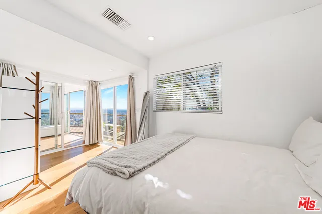 a spacious bedroom with a large bed and a large window