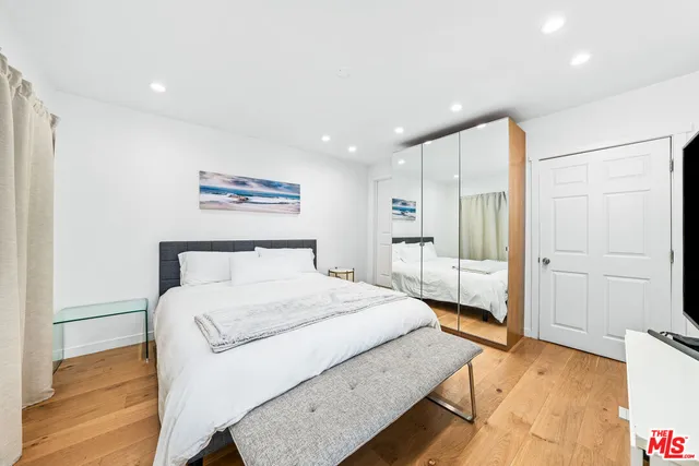 a spacious bedroom with a bed and a view of bathroom