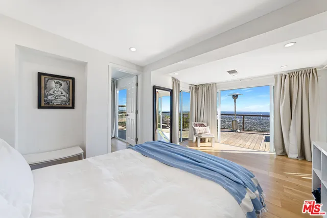 a bedroom with a large bed and a large window