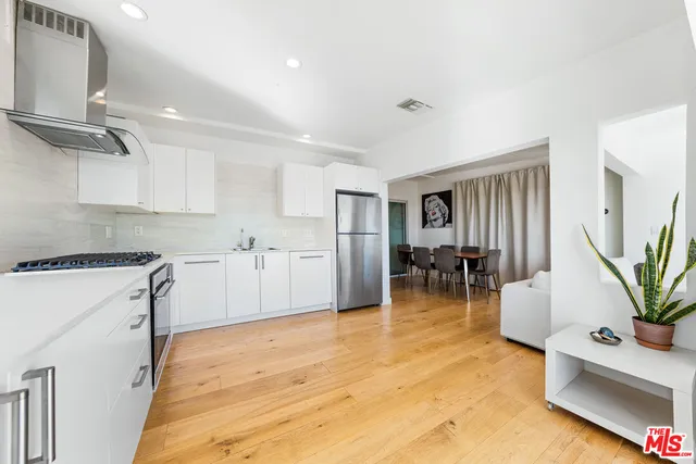 a kitchen with furniture and a refrigerator