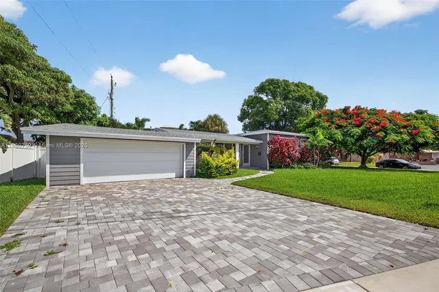 a front view of a house with a yard and a garage