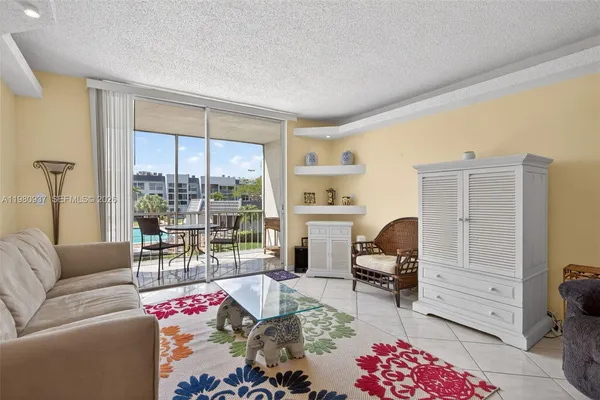 a living room with furniture and a floor to ceiling window