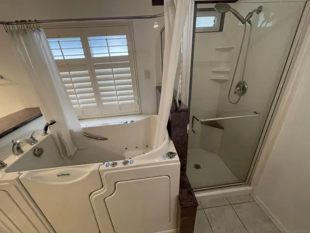 a bathroom with a window and a shower